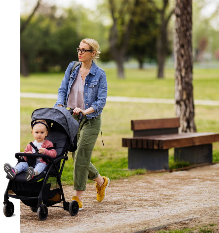 lady with child in stroller in park